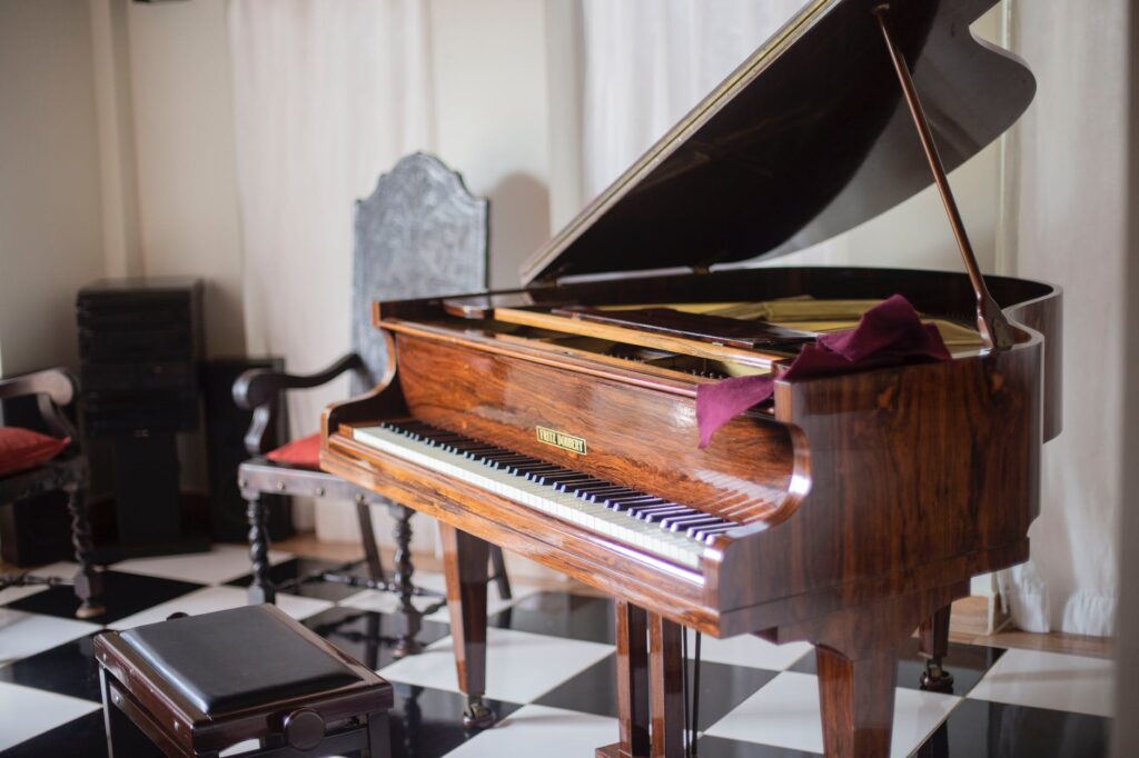 Everything You Need to Know About Piano Tuning brown grand piano with chair