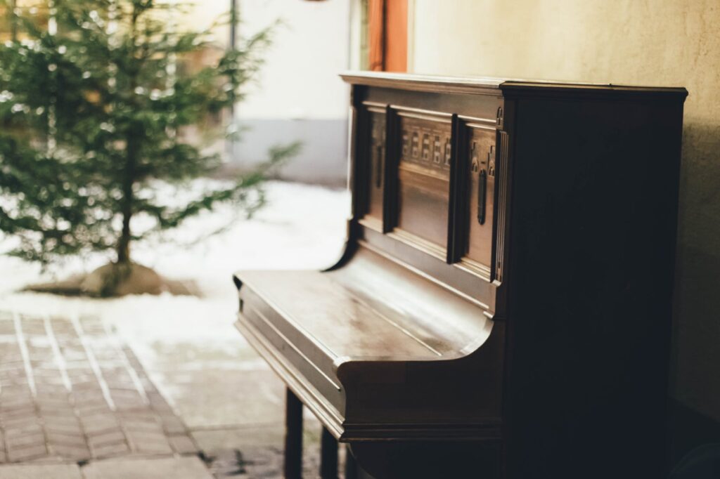 How Often Should You Tune Your Piano? brown wooden upright piano in shallow focus lens